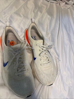 Nike White Sneakers with Blue Swoosh and Orange Heel Detail